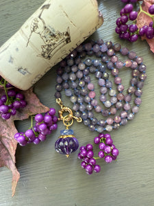 Purple and pink rubies knotted on silk and finished with a 14k gold charm clasp